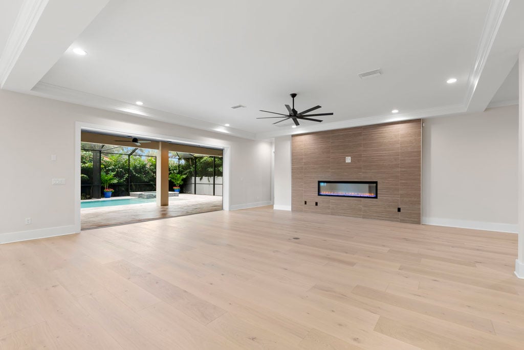 Open-Concept living room - electronic fireplace -Biarritz Builders